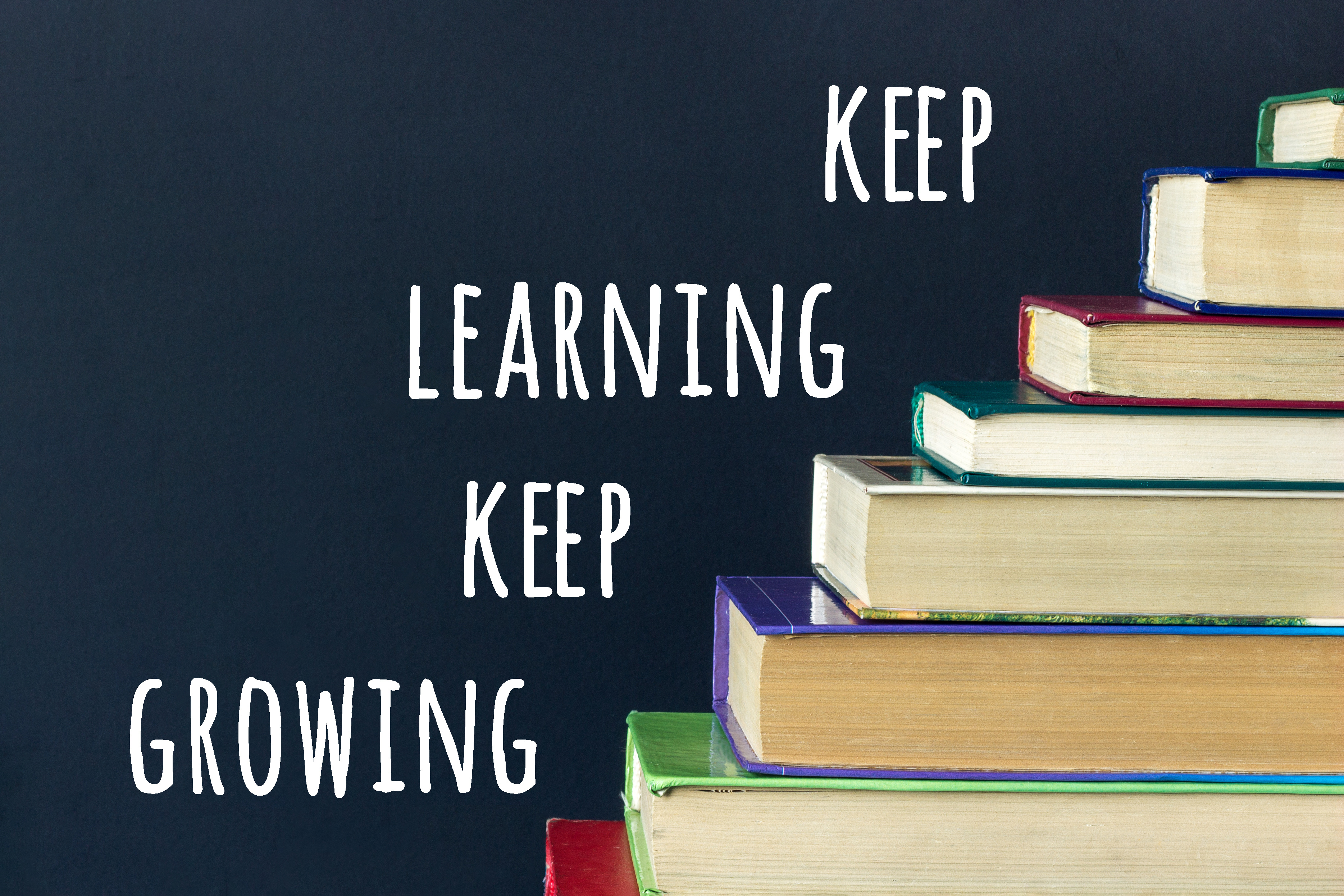 Picture of books with keep learning keep growing written beside them